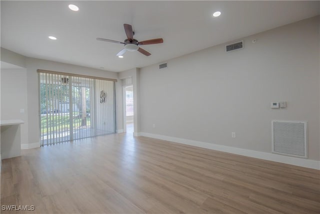 spare room featuring visible vents and light wood-style floors