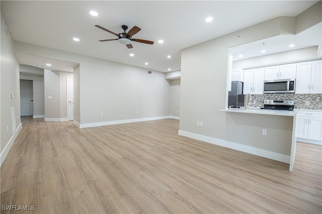 unfurnished living room featuring recessed lighting, baseboards, ceiling fan, and light wood finished floors