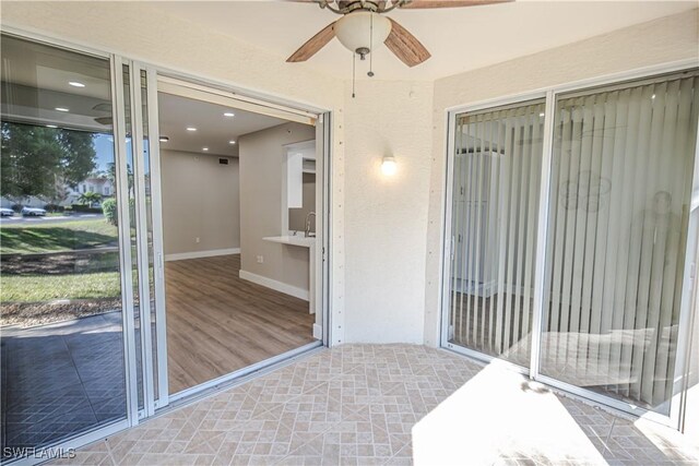 entrance to property with a ceiling fan