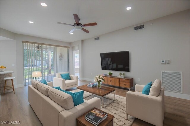 living room featuring visible vents and light wood-style flooring