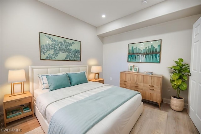 bedroom with baseboards, recessed lighting, and light wood-style floors