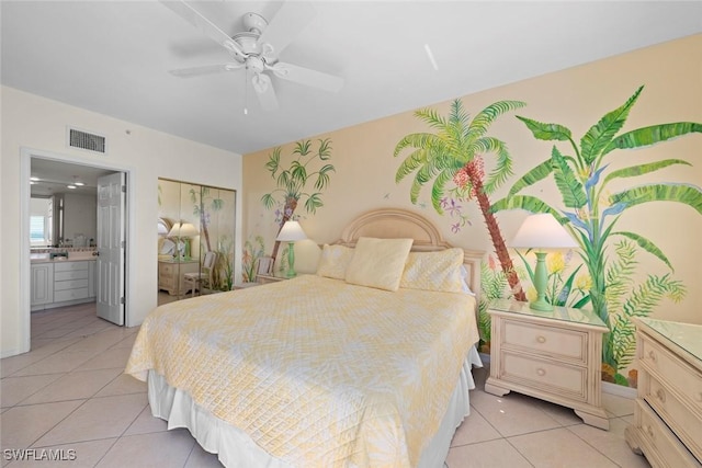 bedroom with light tile patterned floors, ensuite bath, visible vents, and ceiling fan