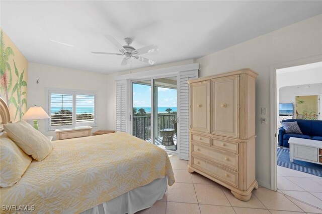 bedroom with access to exterior, ceiling fan, and light tile patterned floors