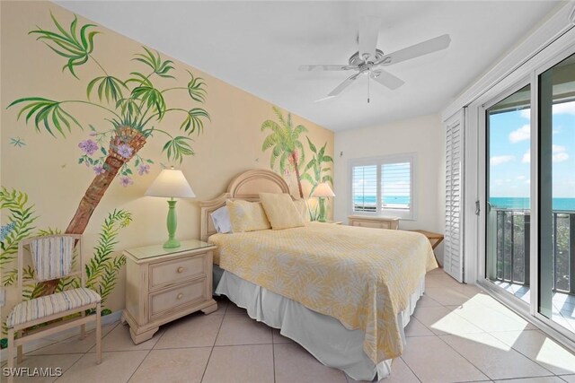 bedroom with access to exterior, ceiling fan, an accent wall, and light tile patterned flooring