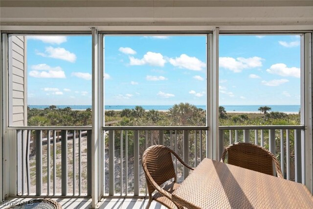 unfurnished sunroom with a water view