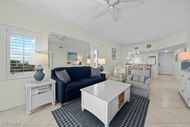 living room with visible vents, ceiling fan with notable chandelier, and light tile patterned flooring