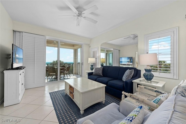 living area featuring a ceiling fan, plenty of natural light, and light tile patterned floors