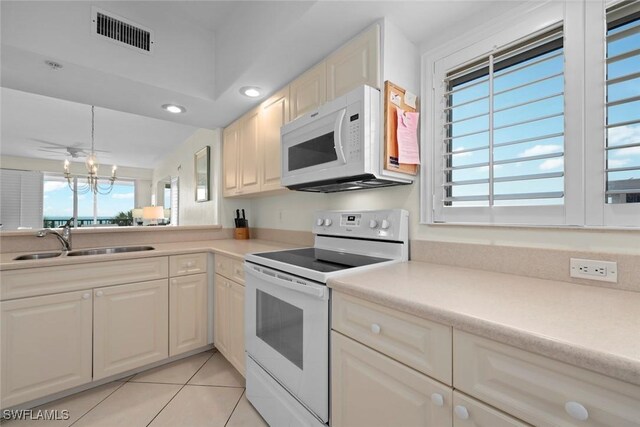 kitchen featuring light countertops, white appliances, a sink, and visible vents