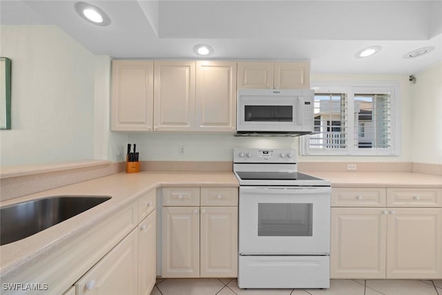 kitchen with white appliances, light countertops, and recessed lighting