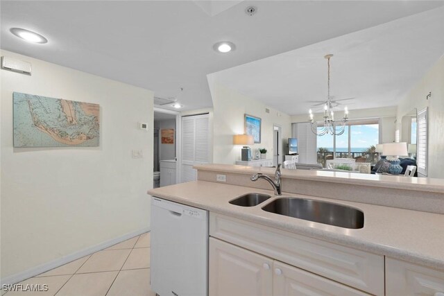 kitchen featuring light tile patterned floors, a notable chandelier, a sink, light countertops, and dishwasher