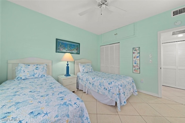 bedroom featuring baseboards, visible vents, a ceiling fan, and light tile patterned flooring