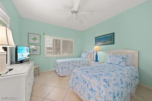 bedroom featuring light tile patterned floors, ceiling fan, and baseboards