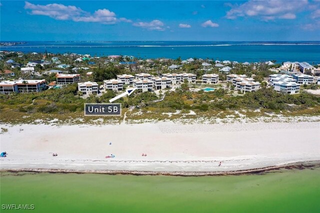 aerial view with a water view and a beach view