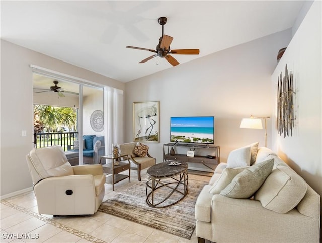 living room with light tile patterned floors, vaulted ceiling, a ceiling fan, and baseboards