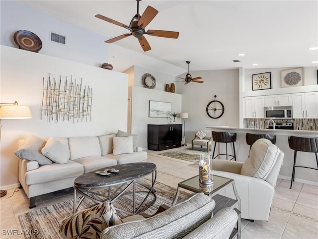 living area featuring baseboards, light tile patterned flooring, visible vents, and recessed lighting