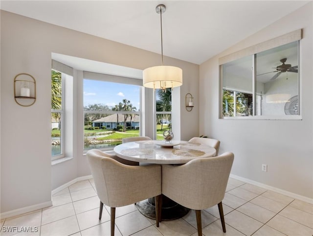 dining area featuring plenty of natural light, light tile patterned flooring, and baseboards