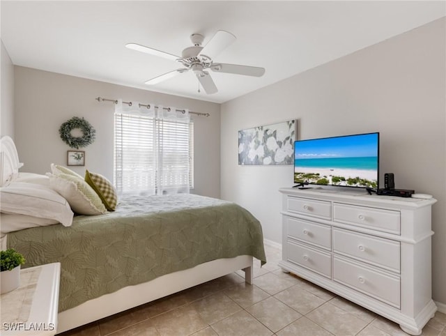 bedroom with light tile patterned floors, baseboards, and a ceiling fan