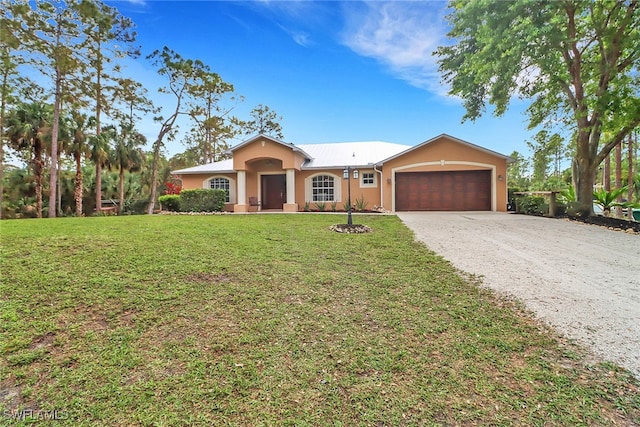 view of front of property with a garage, driveway, a front yard, and stucco siding