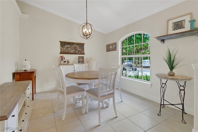 dining room with ornamental molding, an inviting chandelier, light tile patterned flooring, and baseboards