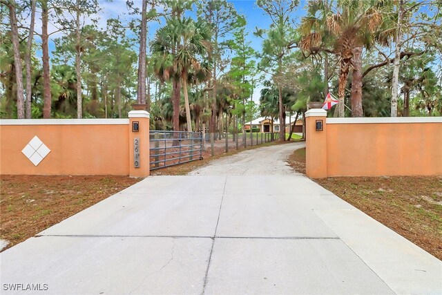 view of gate with a fenced front yard