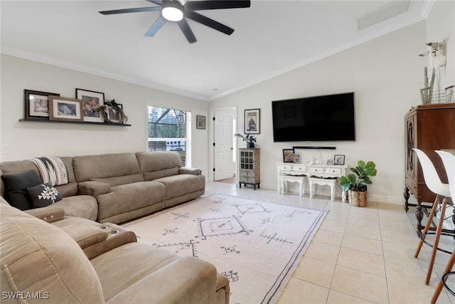 living room with lofted ceiling, ornamental molding, a ceiling fan, tile patterned flooring, and baseboards