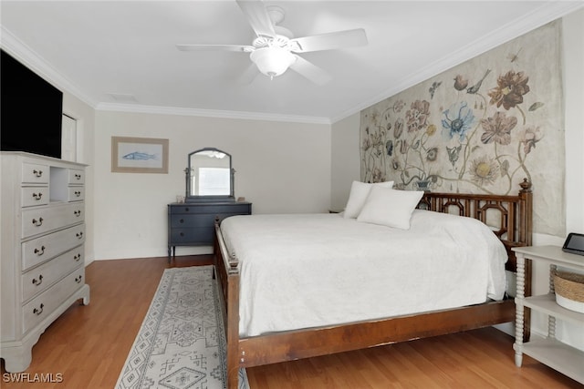 bedroom with ceiling fan, ornamental molding, and light wood-style flooring