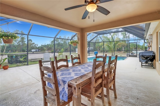 exterior space featuring a ceiling fan, a lanai, a grill, and an outdoor pool