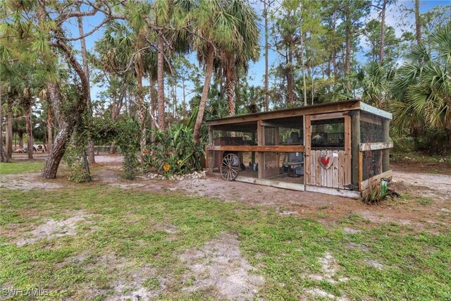 view of yard featuring an outbuilding and exterior structure