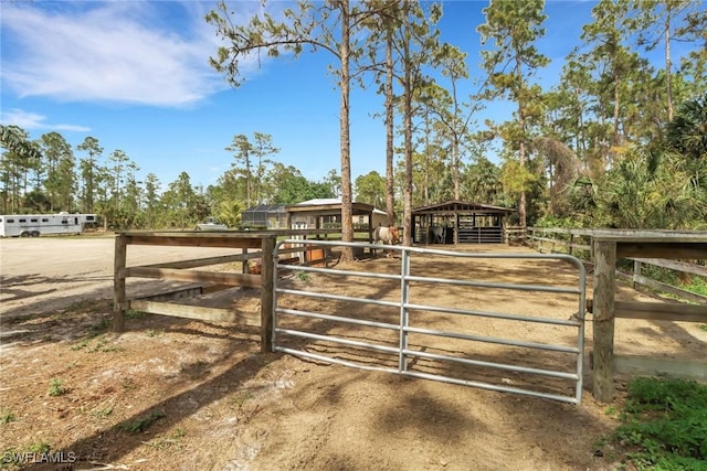 view of gate featuring an outbuilding and an exterior structure