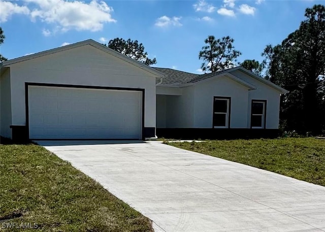 single story home with an attached garage, a front yard, concrete driveway, and stucco siding