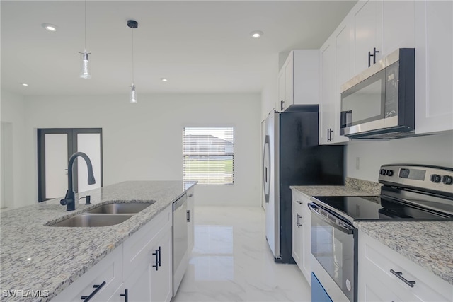 kitchen with marble finish floor, appliances with stainless steel finishes, white cabinets, and a sink