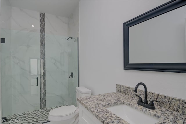 bathroom with toilet, vanity, and a marble finish shower