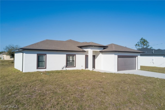 view of front of property with a garage, stucco siding, concrete driveway, and a front yard