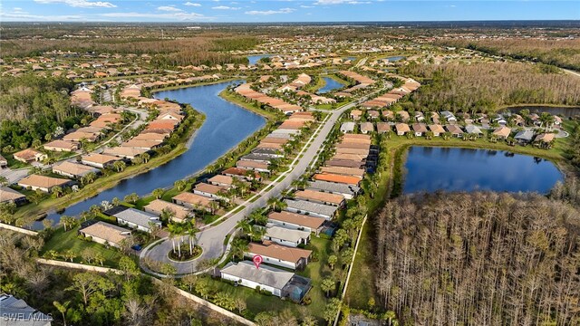 drone / aerial view featuring a water view and a residential view