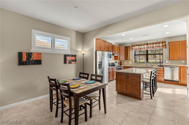 dining space featuring light tile patterned floors, recessed lighting, and baseboards