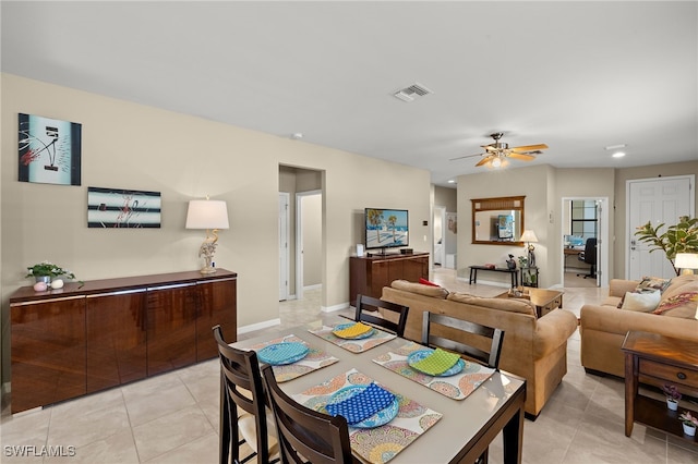 dining room featuring light tile patterned floors, baseboards, visible vents, and a ceiling fan