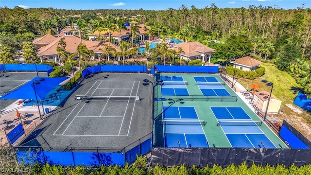 birds eye view of property featuring a view of trees