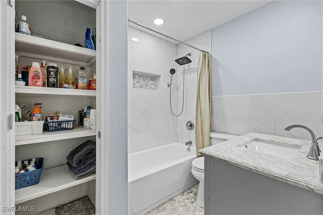 bathroom featuring vanity, shower / bath combo with shower curtain, and toilet