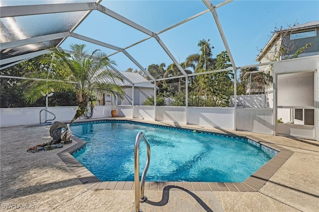 view of pool with a patio area, glass enclosure, and a fenced in pool