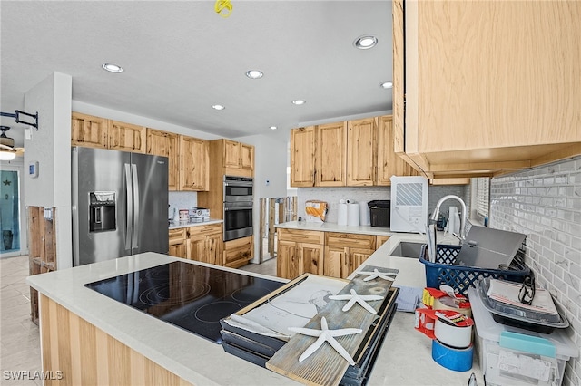 kitchen with light countertops, appliances with stainless steel finishes, backsplash, and recessed lighting