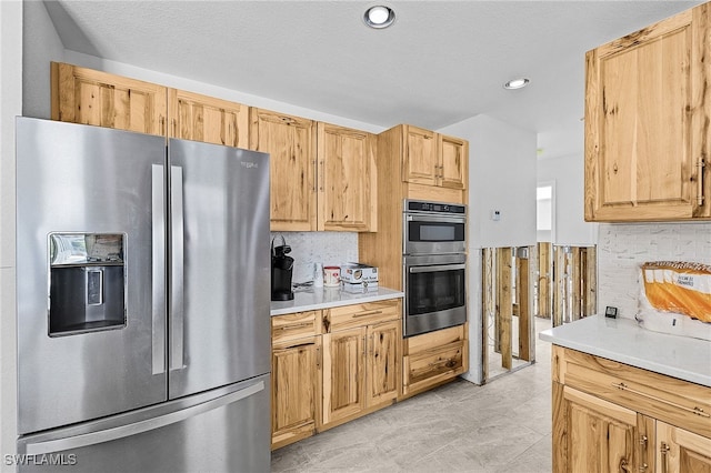 kitchen with stainless steel appliances, recessed lighting, light countertops, and backsplash