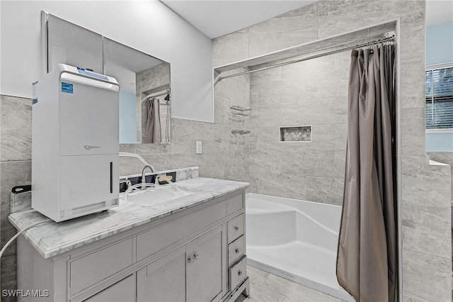 full bathroom featuring shower / bath combination with curtain, tile walls, and vanity