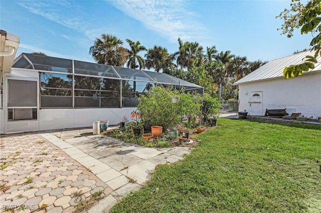 view of yard with a lanai and a patio