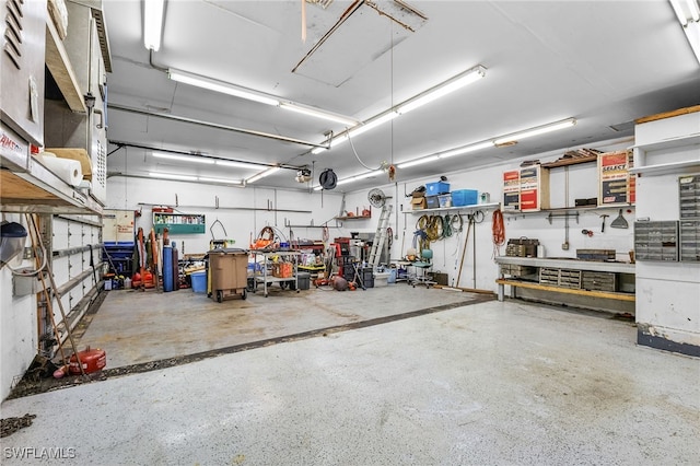 garage with a garage door opener and a workshop area