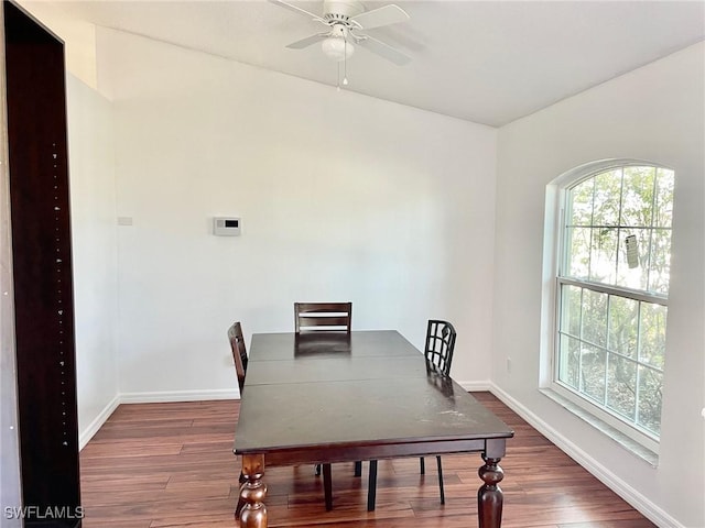 dining room featuring a ceiling fan, baseboards, and wood finished floors