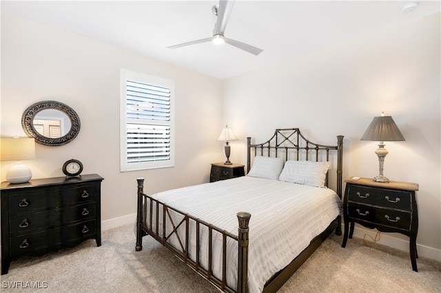 bedroom with a ceiling fan, carpet, and baseboards