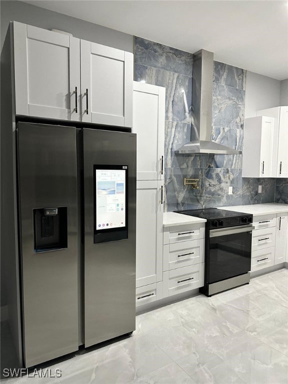 kitchen with stainless steel fridge with ice dispenser, light countertops, electric range, and wall chimney exhaust hood