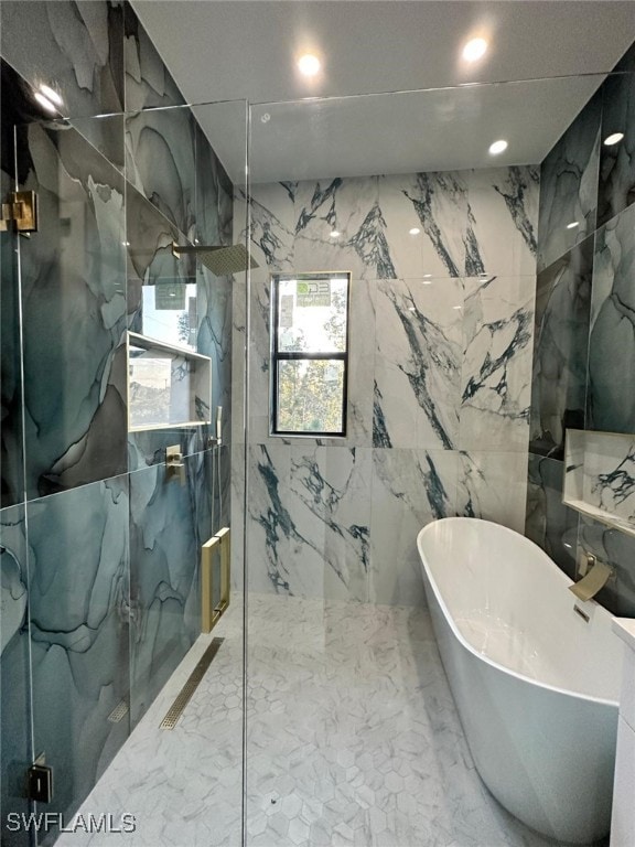 bathroom featuring stone wall, a marble finish shower, and marble finish floor