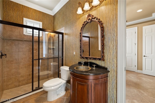 bathroom with a stall shower, baseboards, toilet, crown molding, and vanity