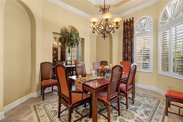 dining room with arched walkways, baseboards, a chandelier, and crown molding